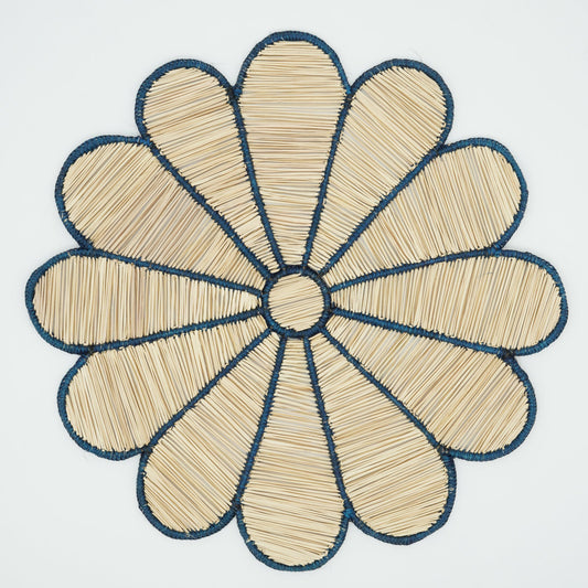Overhead view of woven blue flower placemat.