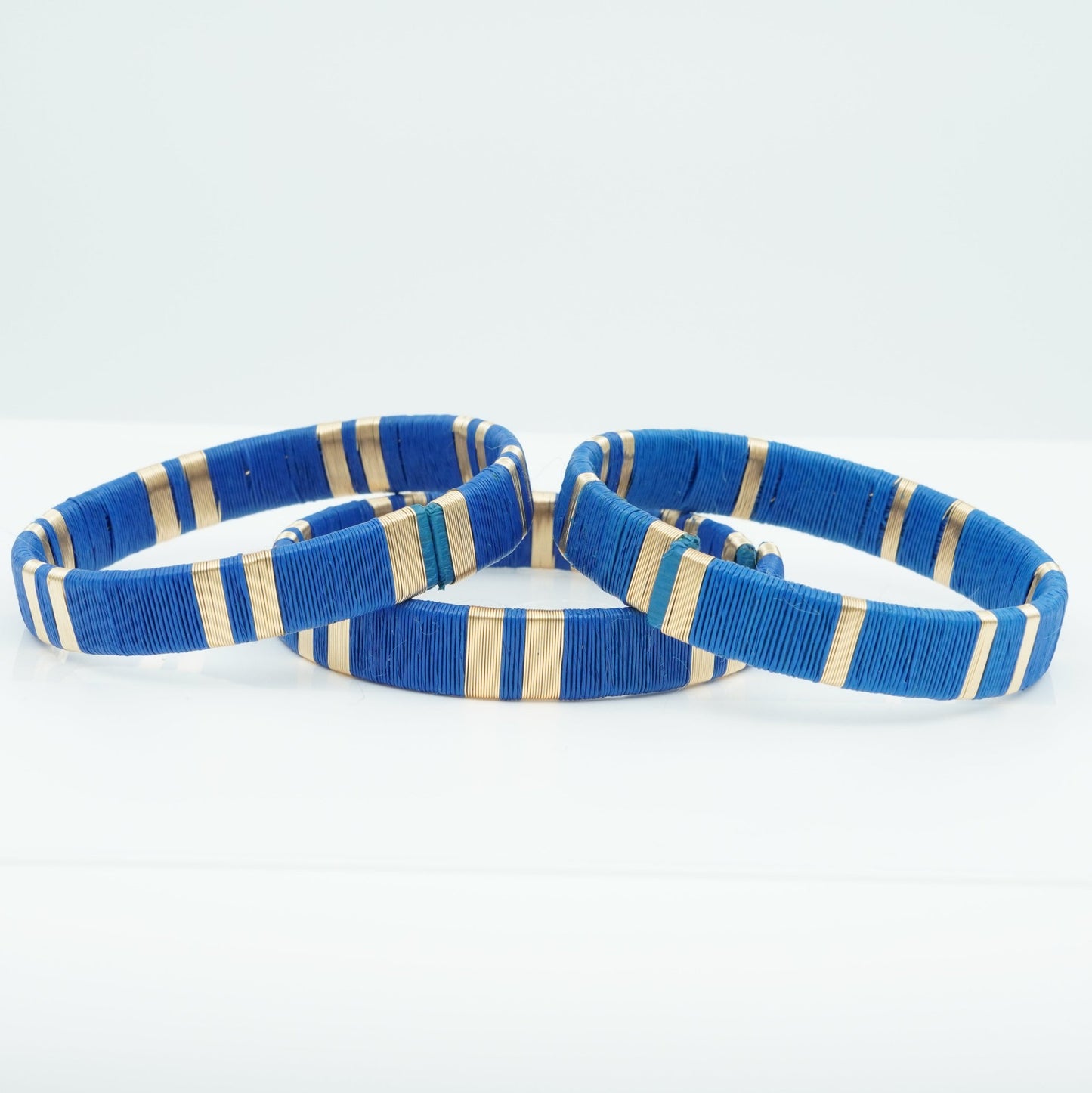 Bracelets made of blue werregue palm fiber and gold wire.