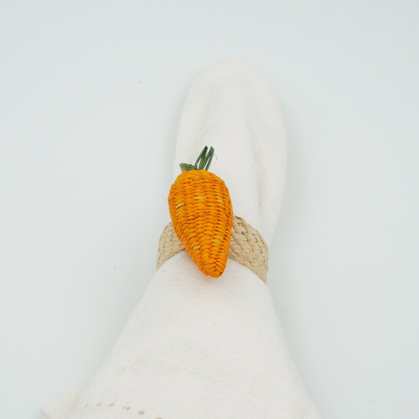 Head-on view of woven carrot napkin ring.