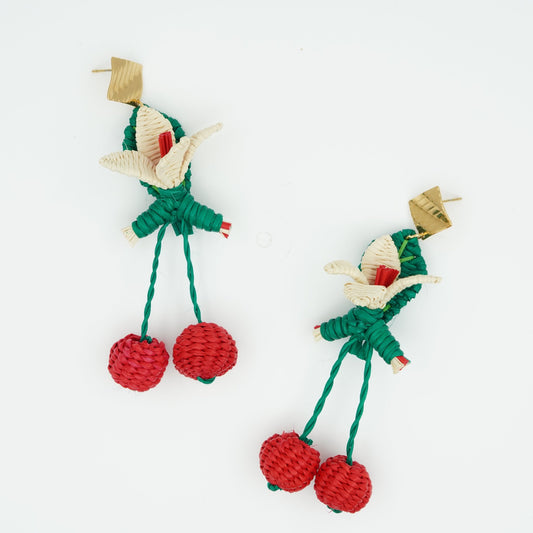 Overhead view of woven cherry dangly earrings.