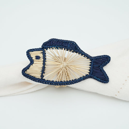 A side view of a blue and natural woven napkin ring in the shape of a fish.