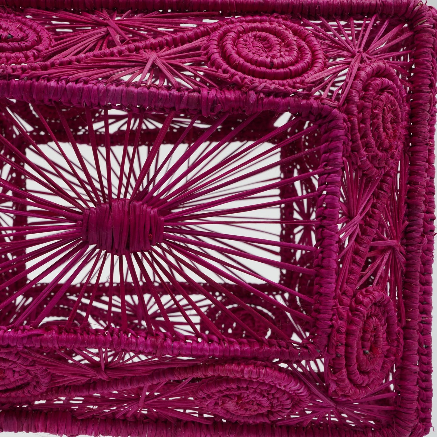 Close up view of woven fuchsia lunchbox purse.