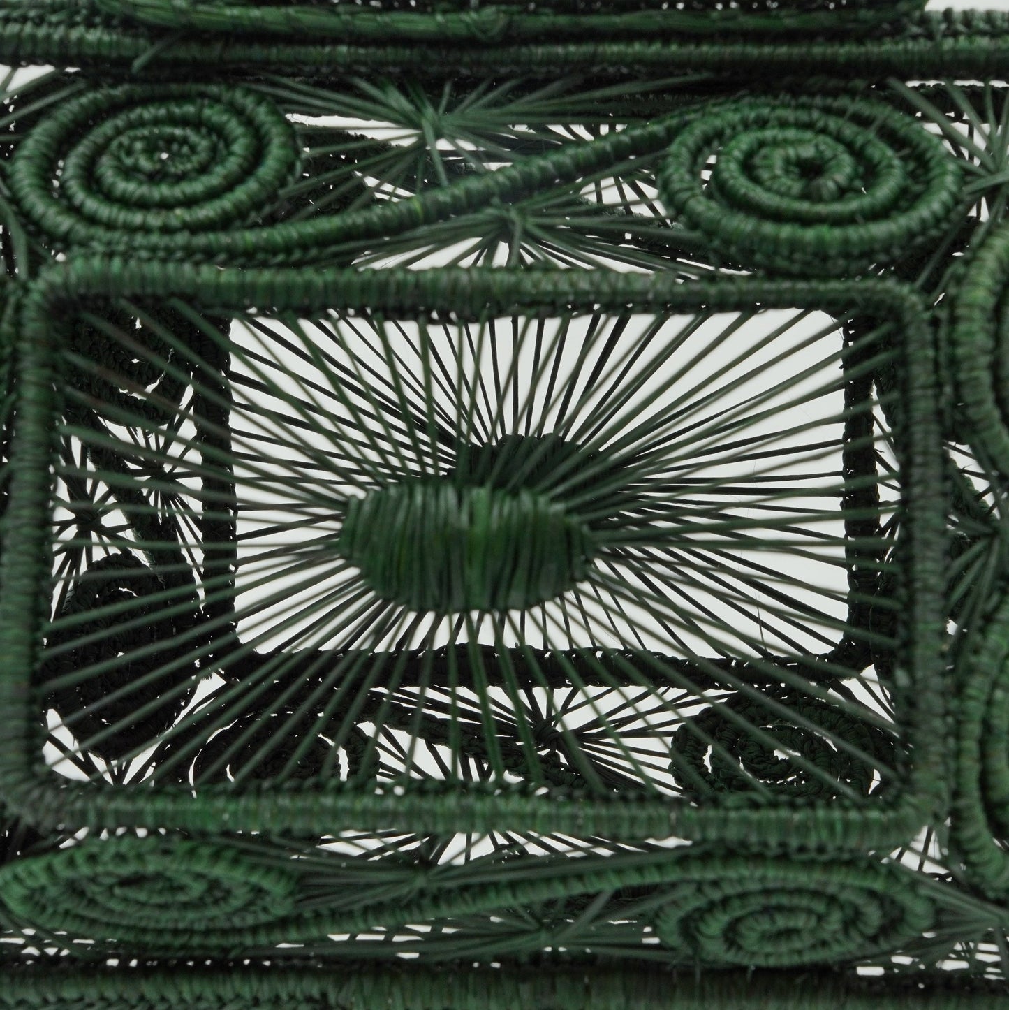 Close up view of woven green lunchbox purse.