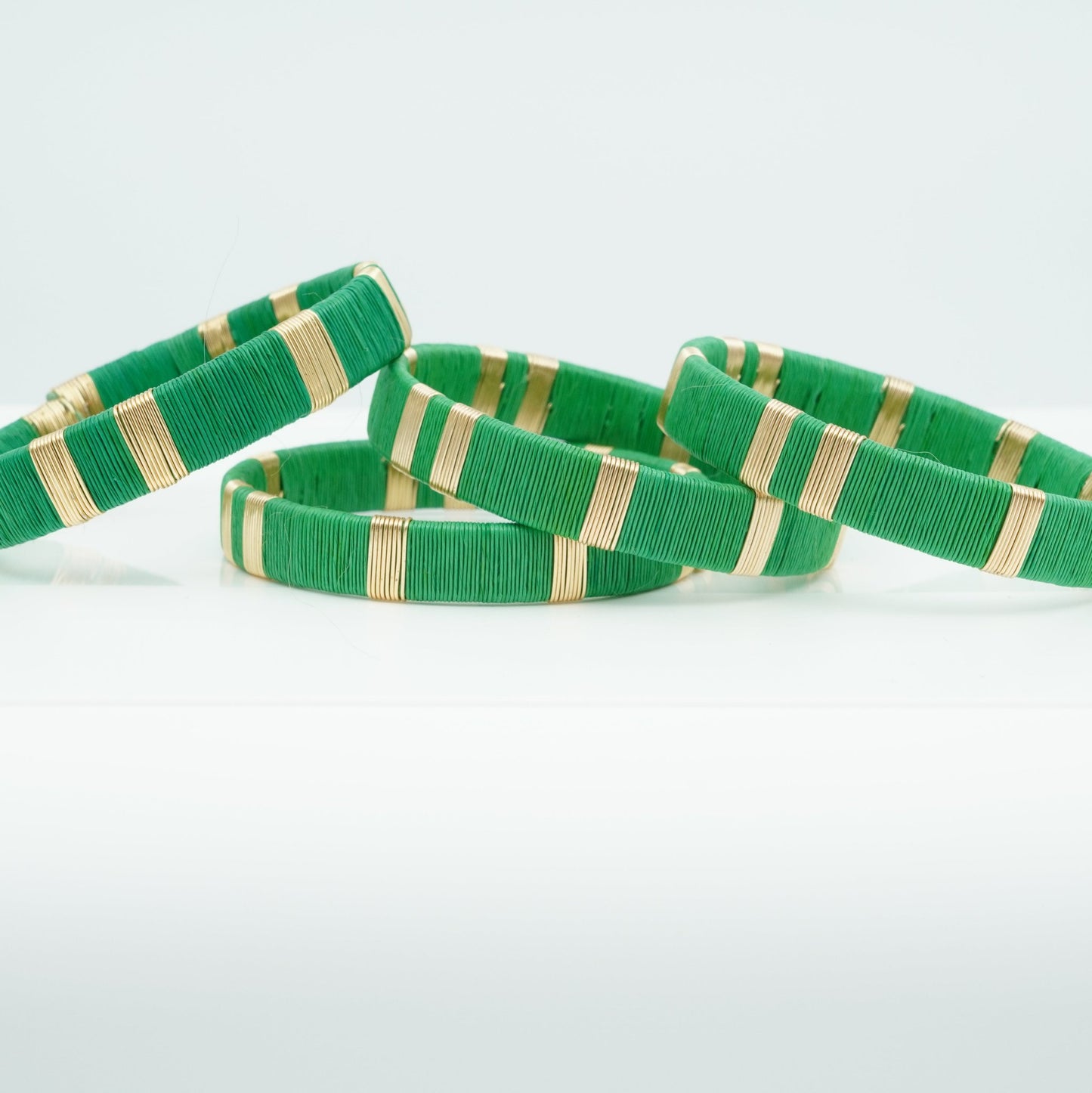 Bracelets made of green werregue palm fiber and gold wire.