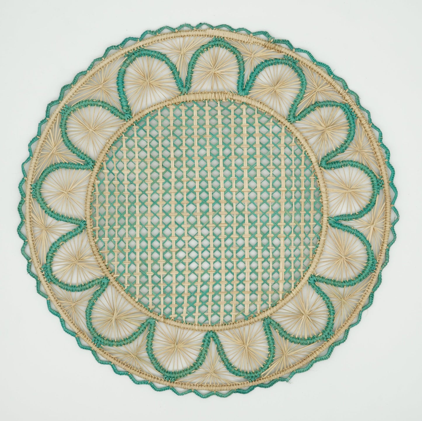 Overhead view of half moon patterned woven placemat in blue and natural.