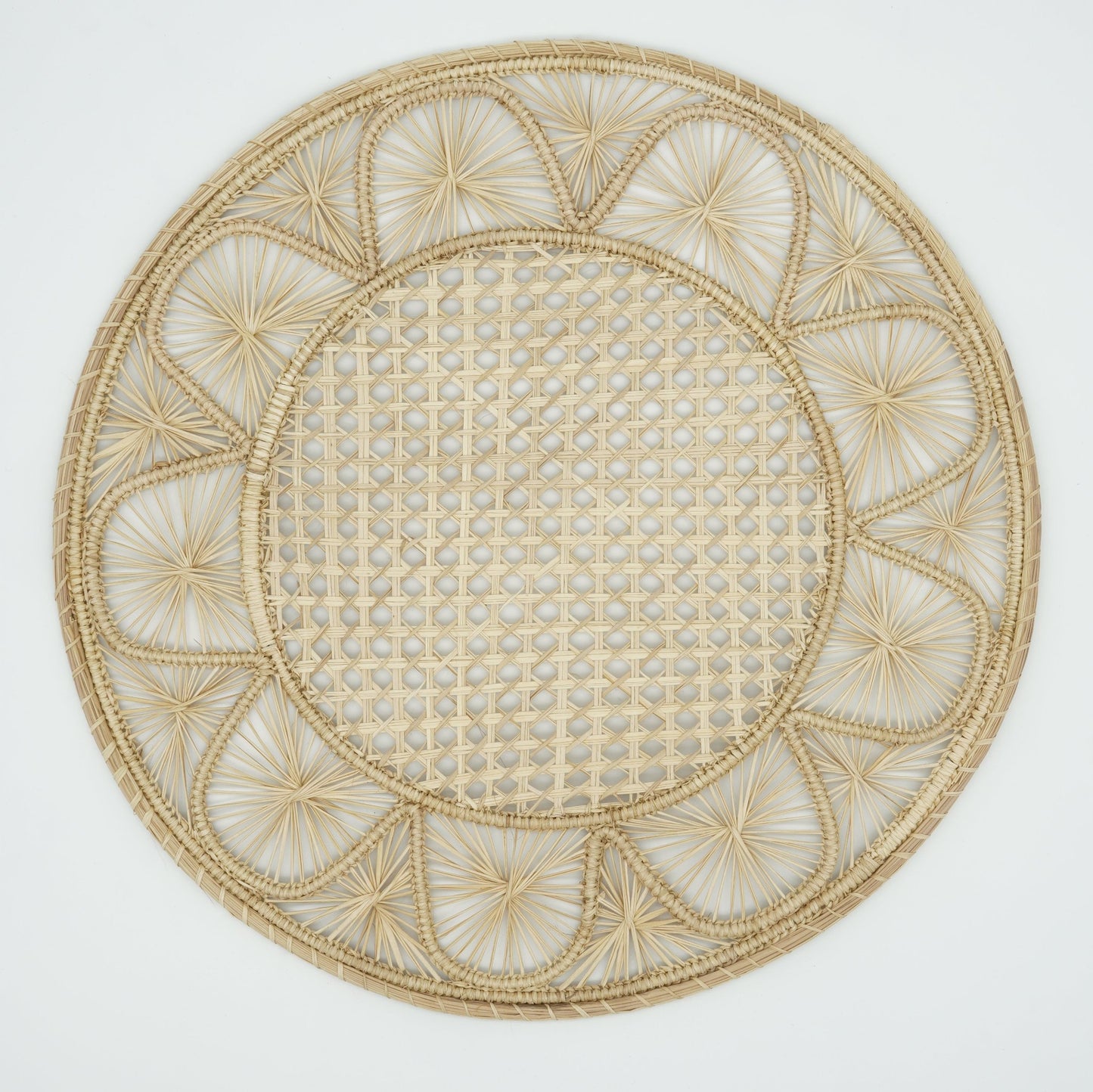 Overhead view of half moon patterned woven placemat in natural.