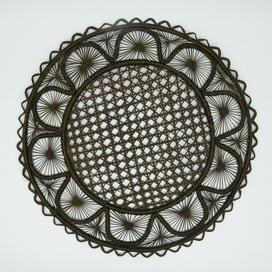 Overhead view of half moon patterned woven placemat in olive green.