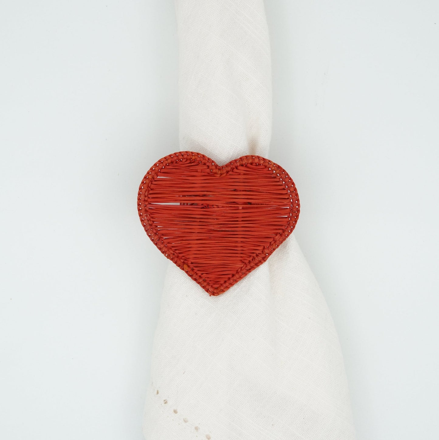 Overhead view of woven heart napkin ring.