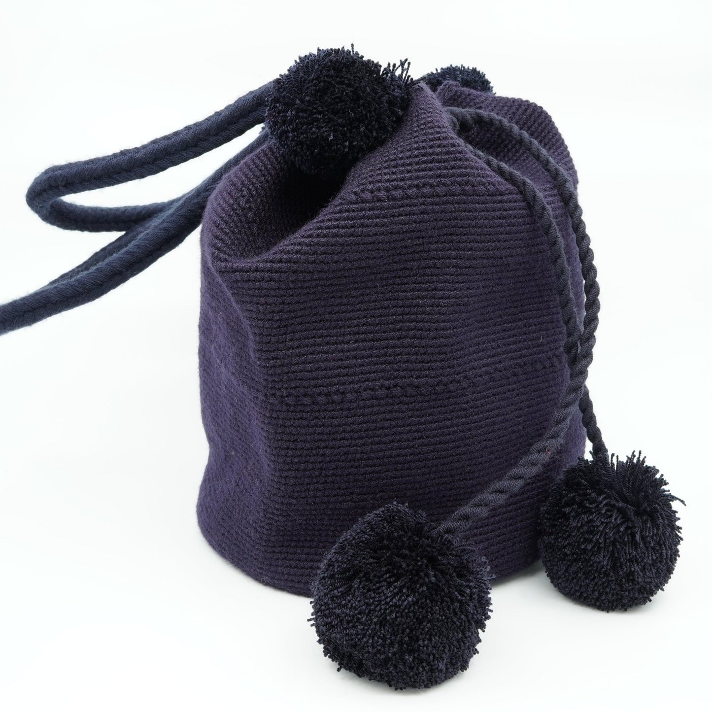 Large navy mochila woven handbag with pompoms.
