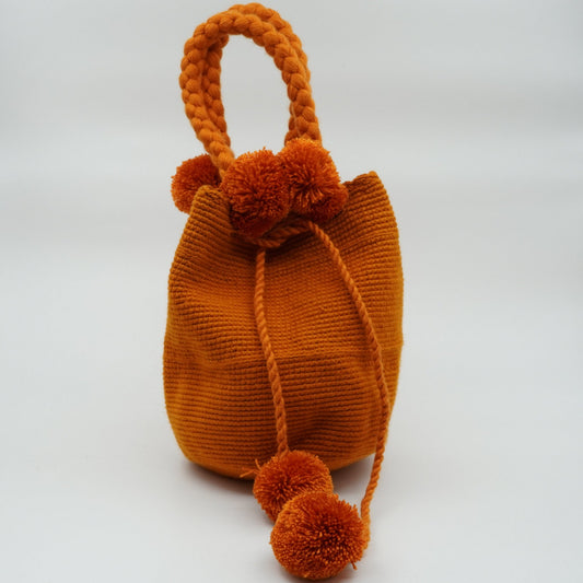 Medium orange mochila woven handbag with pompoms.