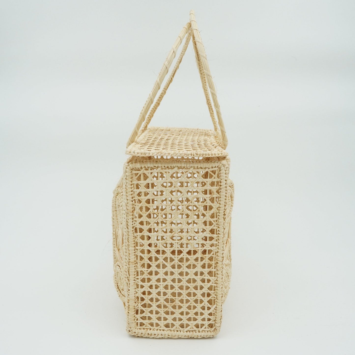 Side view of woven natural lunchbox purse.