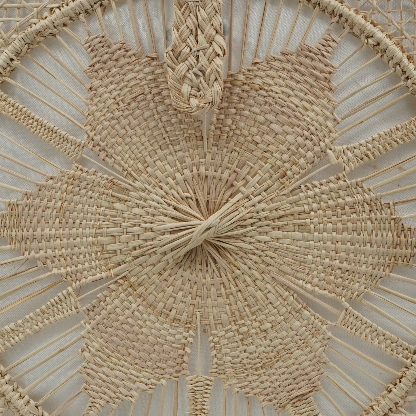 Close up view of natural woven square flower purse.