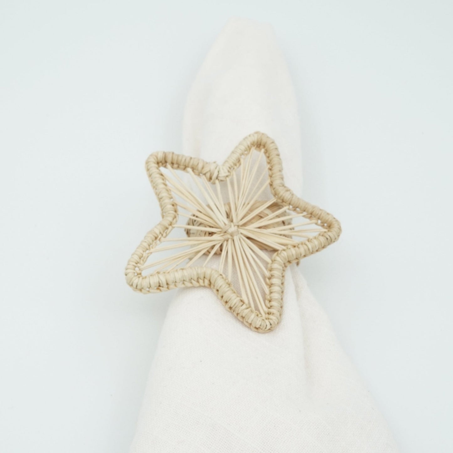Head on view of woven natural star napkin ring.