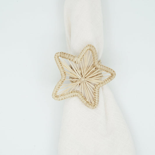 Overhead view of woven natural star napkin ring.