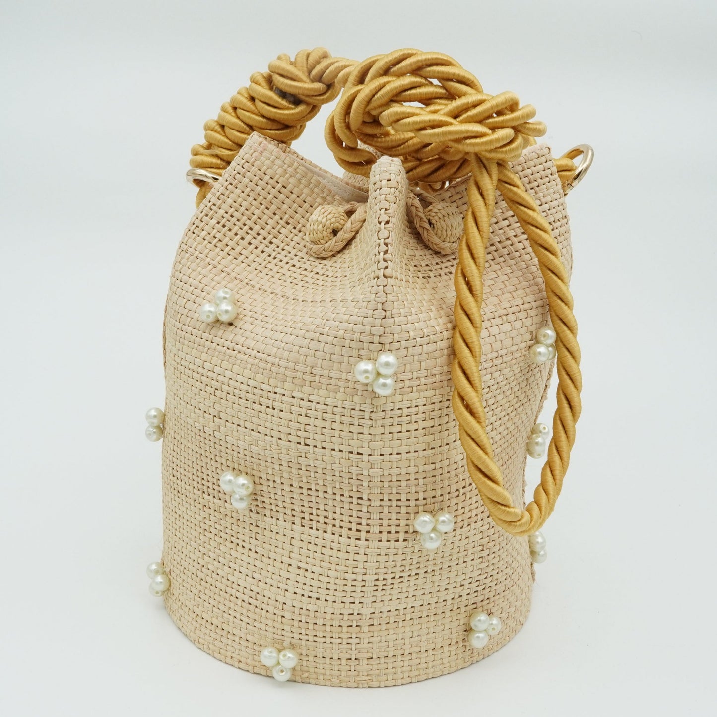 Woven pearl bucket bag with gold strap.