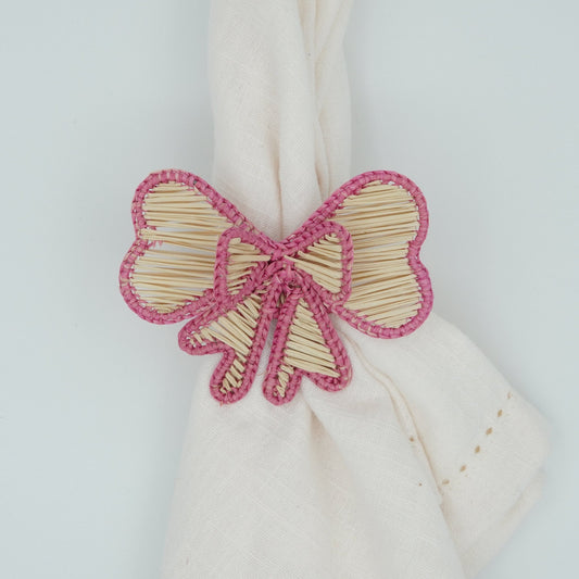 Overhead view of woven pink bow napkin rings.