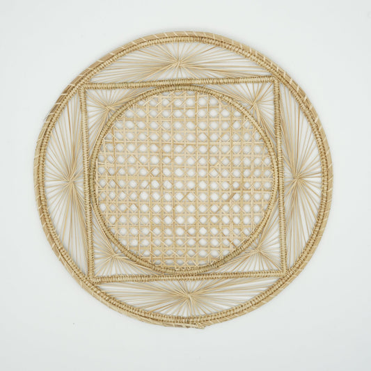 Overhead view of woven natural placemat with square design.