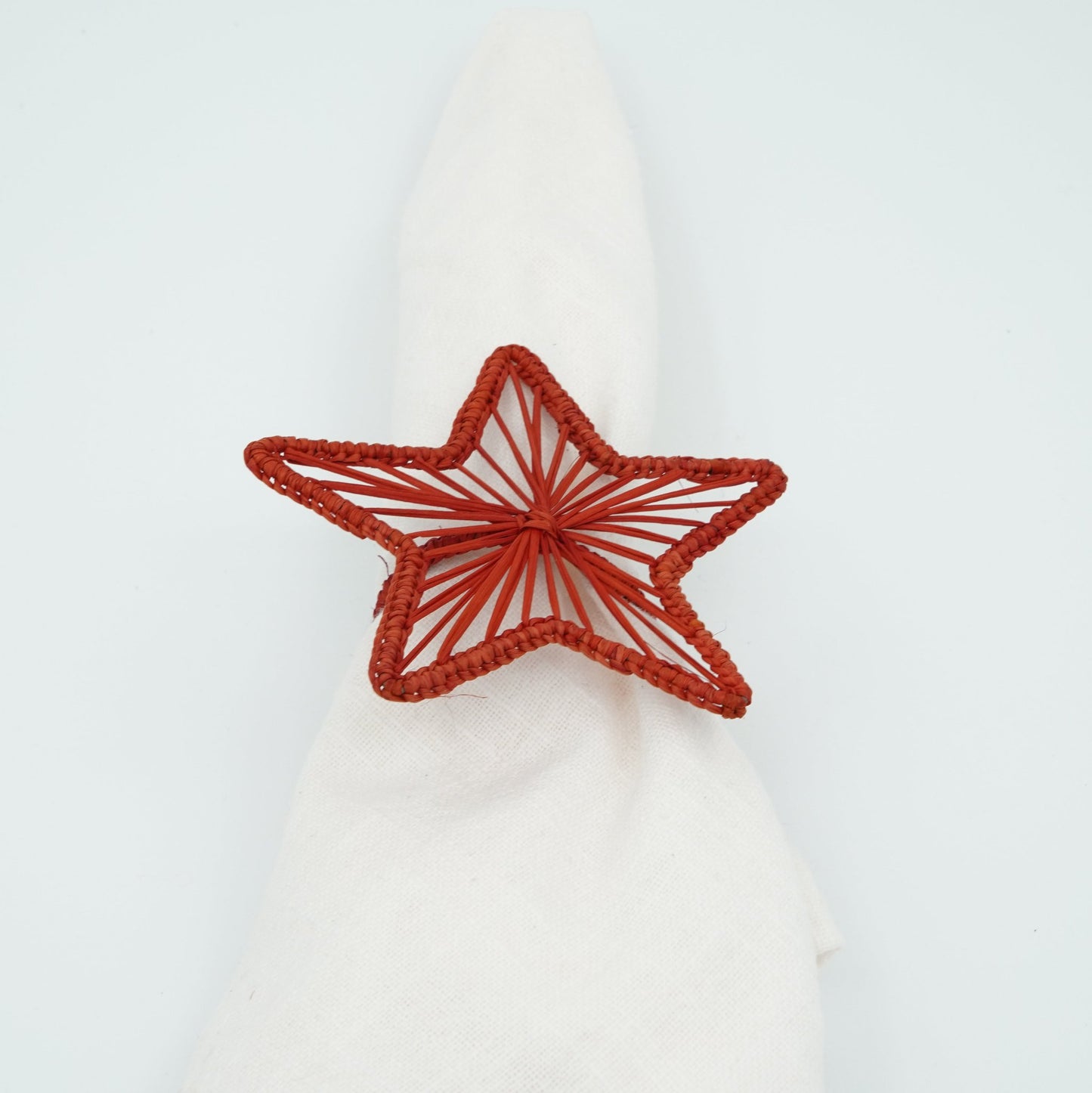 Head on view of woven red star napkin ring.