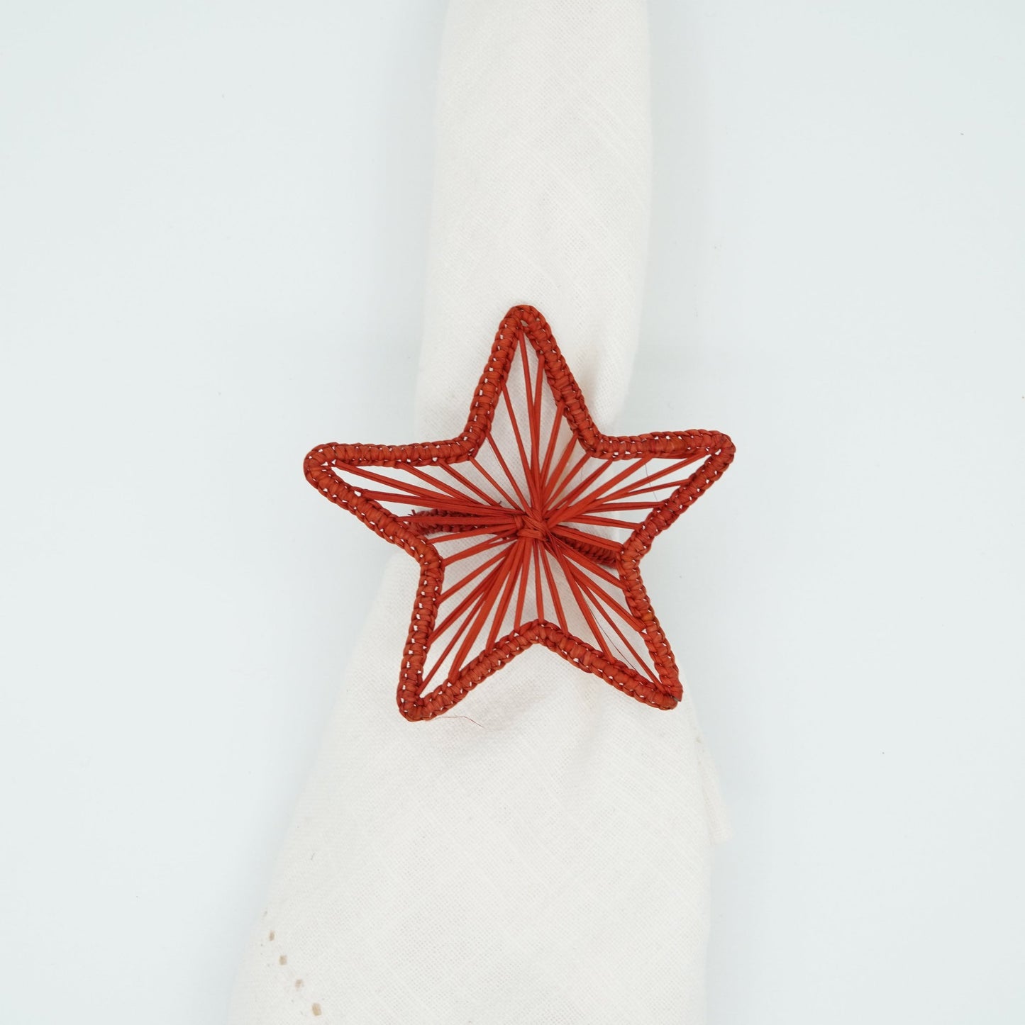 Overhead view of woven red star napkin ring.