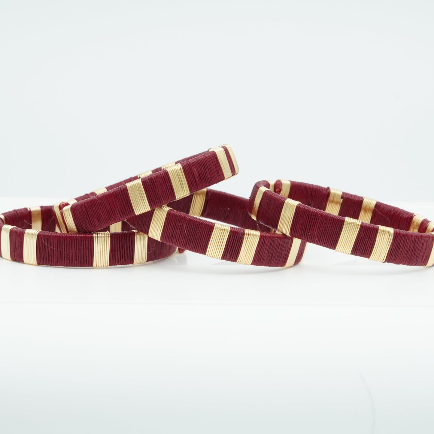 Bracelets made of wine werregue palm fiber and gold wire.