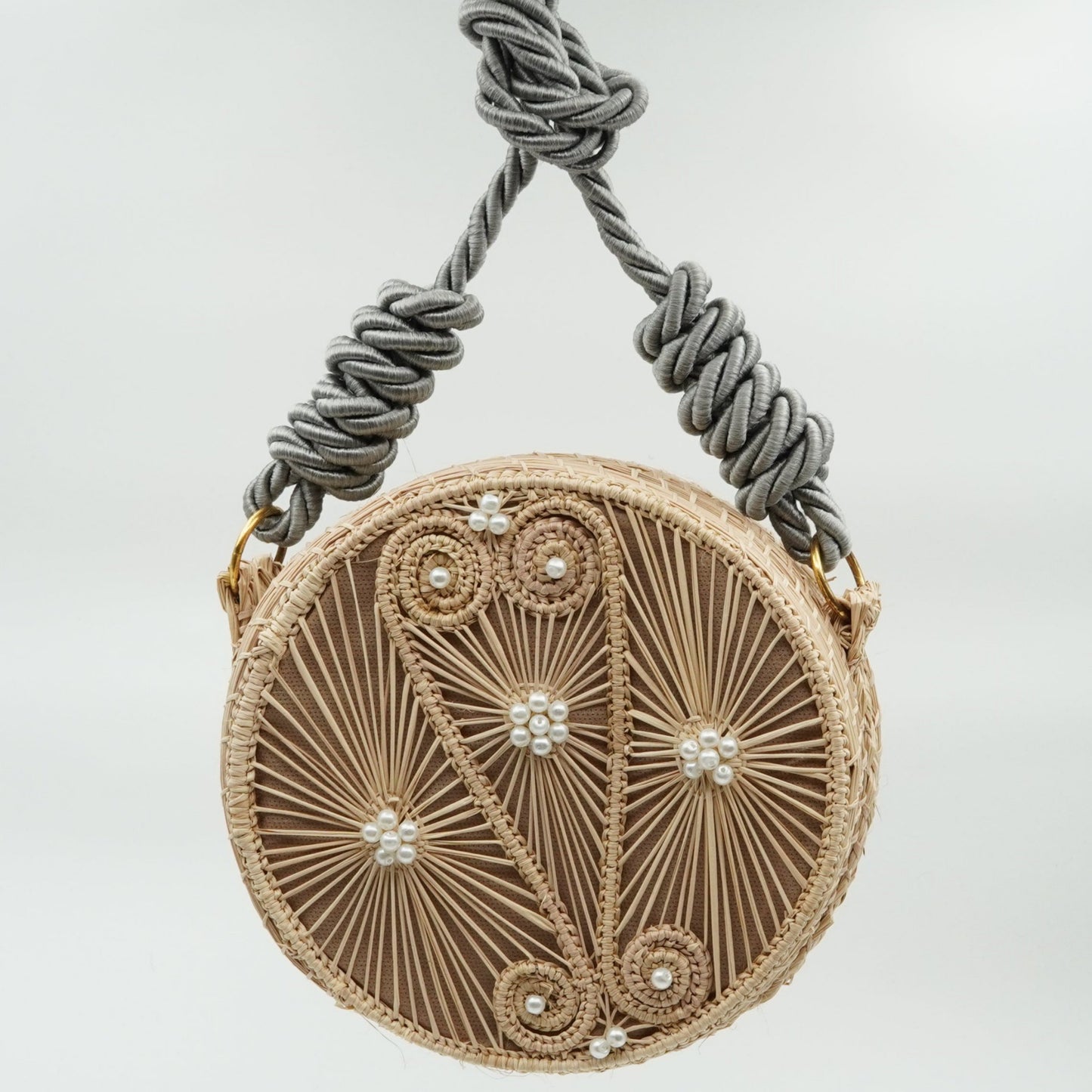 Woven yoyo purse with design with white beads and silver strap.
