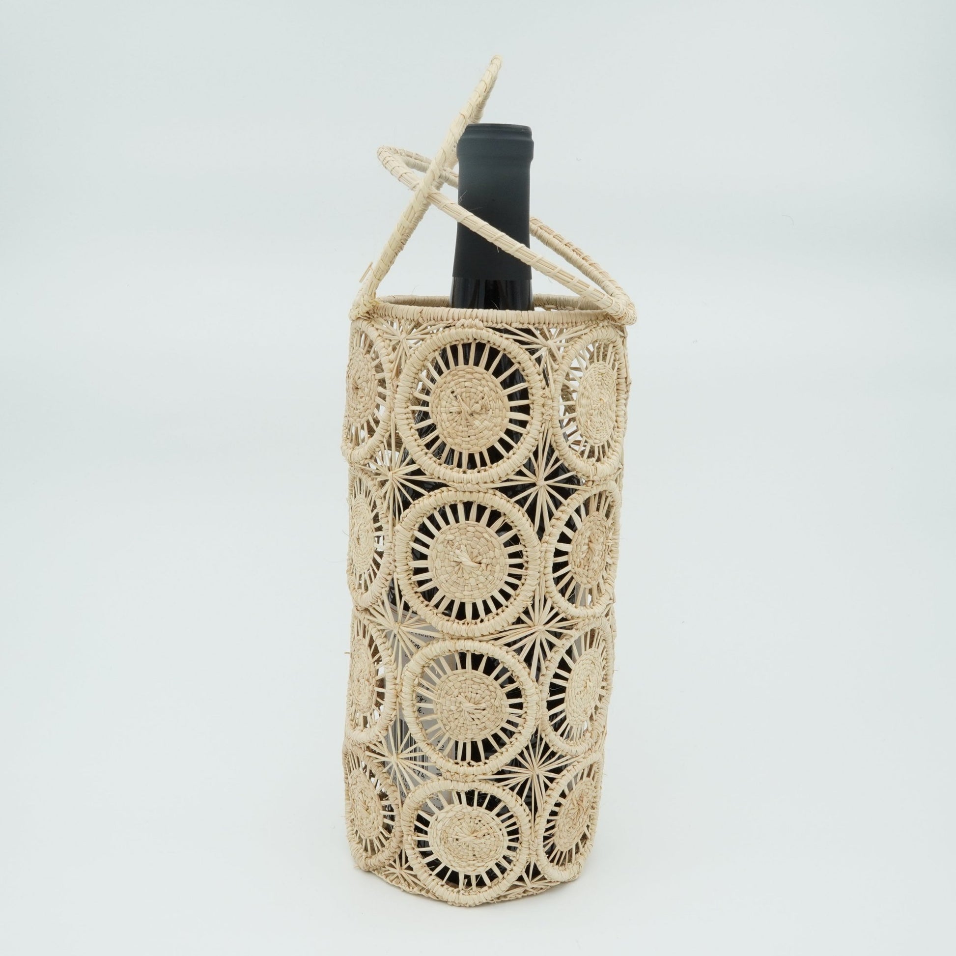 Head on view of circles round woven wine basket with wine.