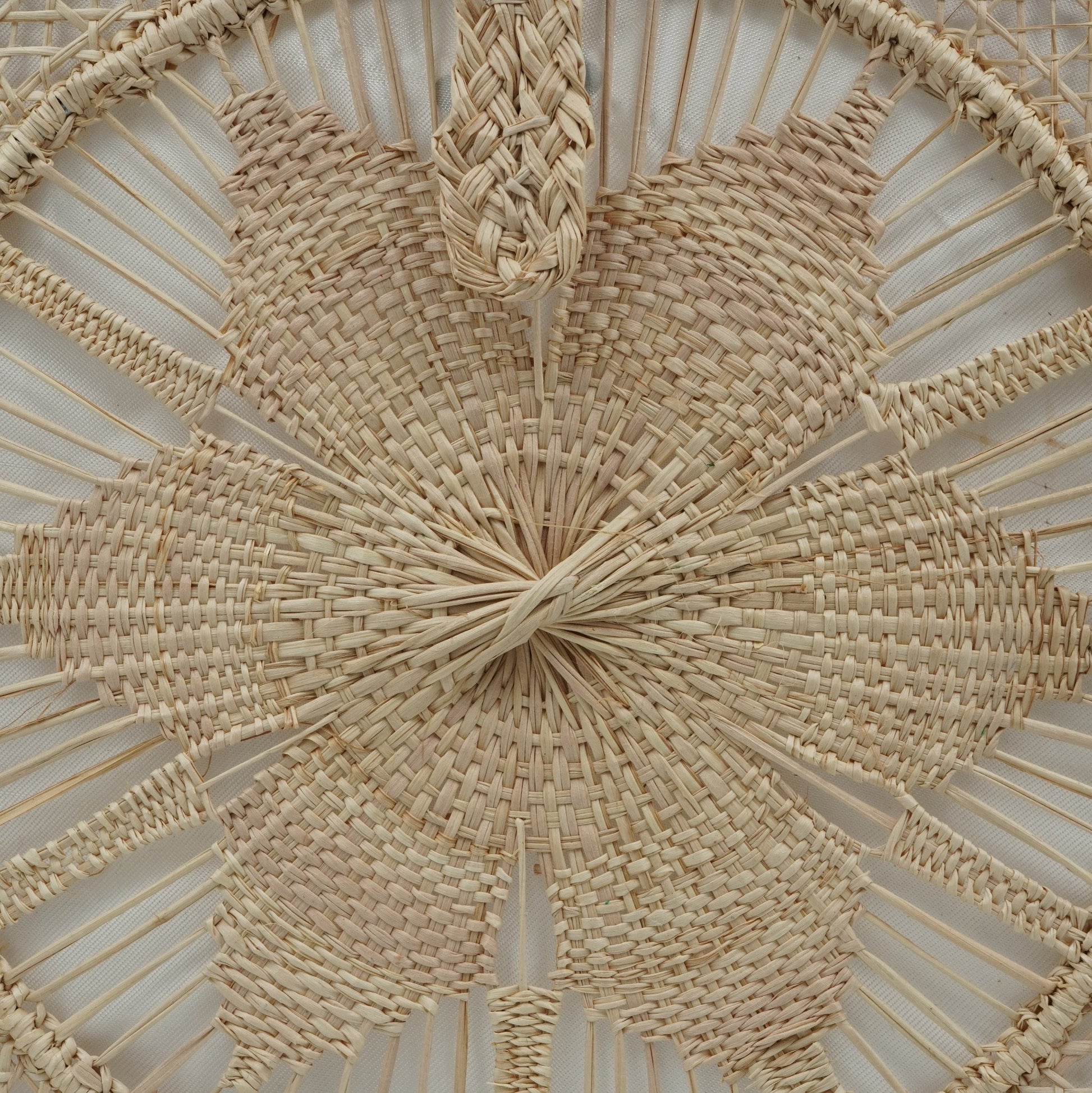 Close up view of natural woven square flower purse.