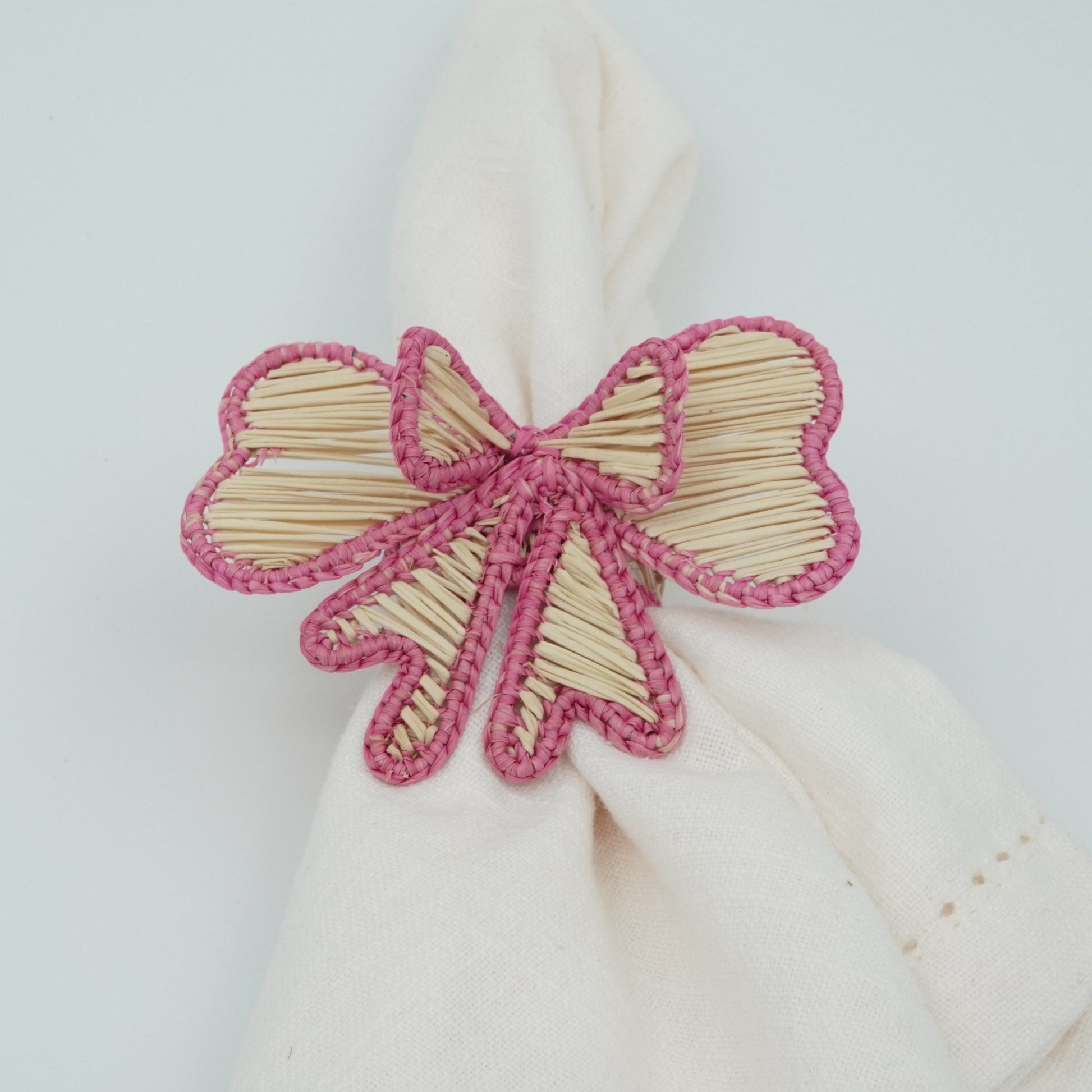 Direct view of woven pink bow napkin rings.