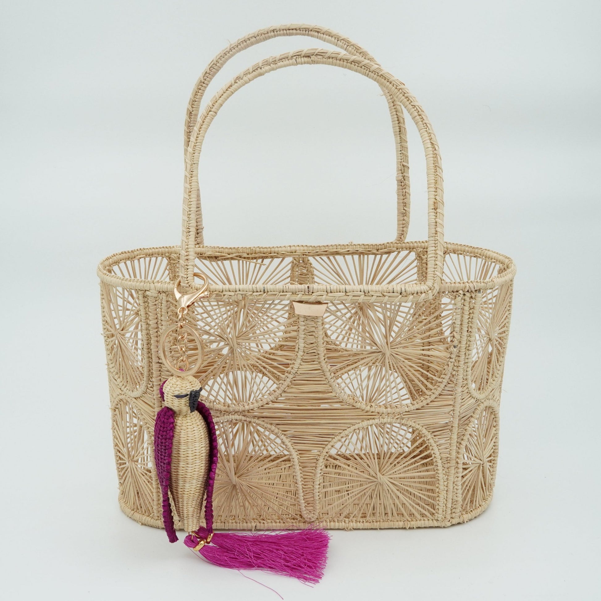 Woven purse with semicircle pattern featuring a parrot charm.
