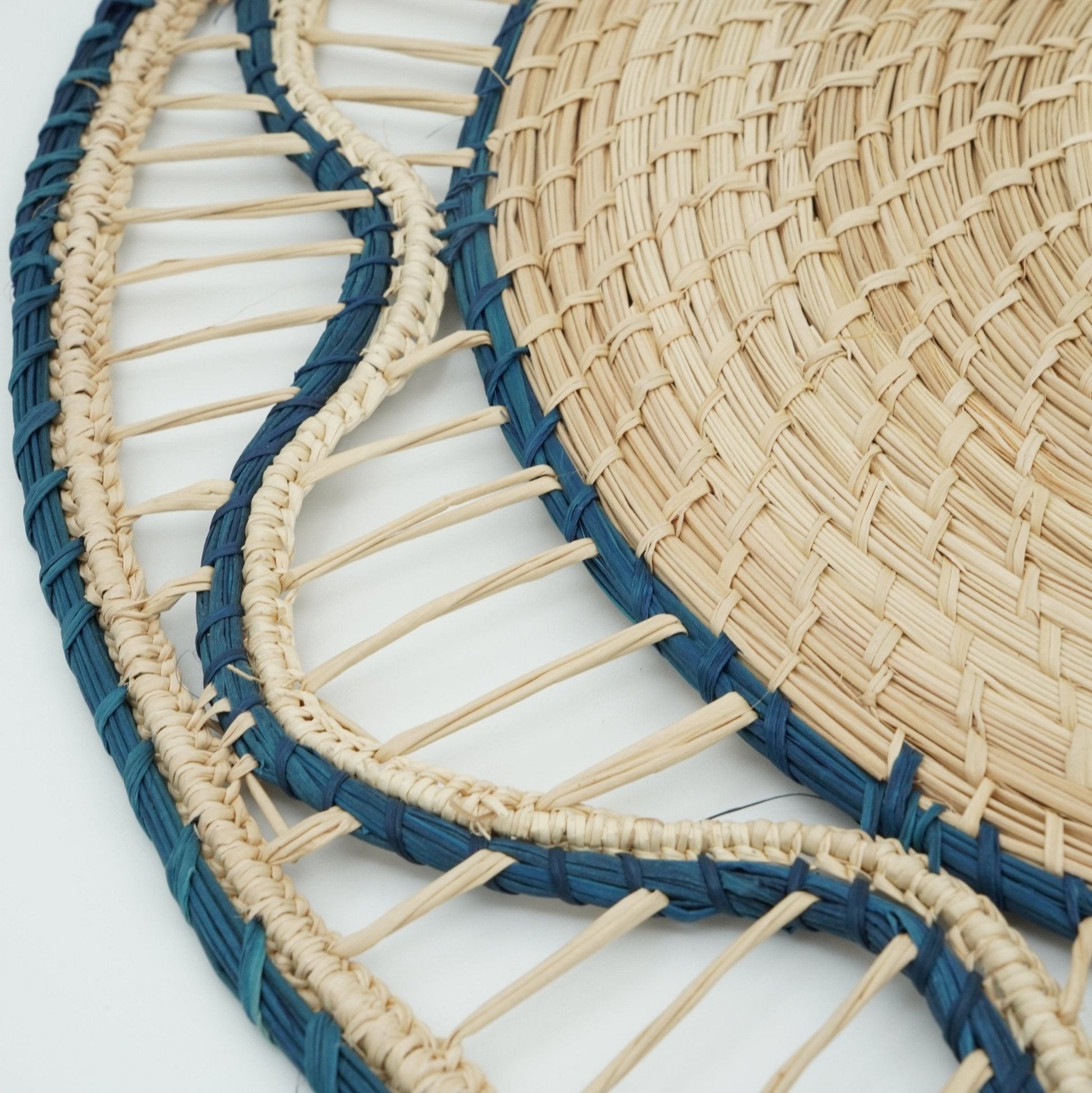 Close up view of blue woven small wave border placemat.